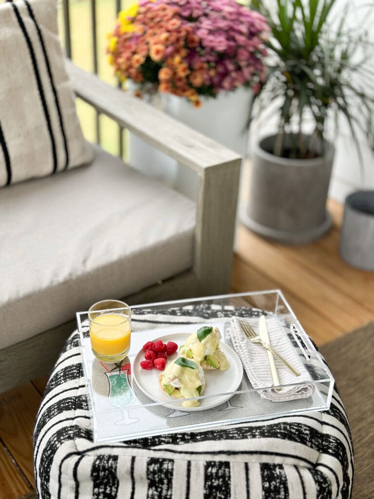 acrylic tray holding brunch items sitting on an outdoor patio