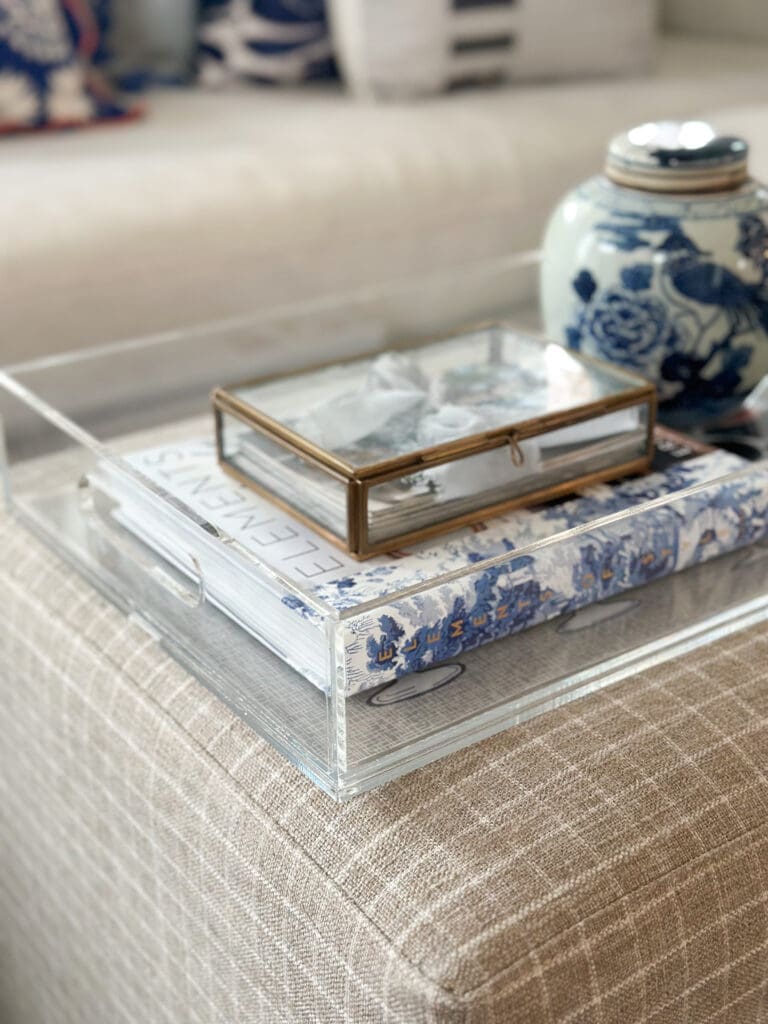 acrylic tray on ottoman with blue and white decor