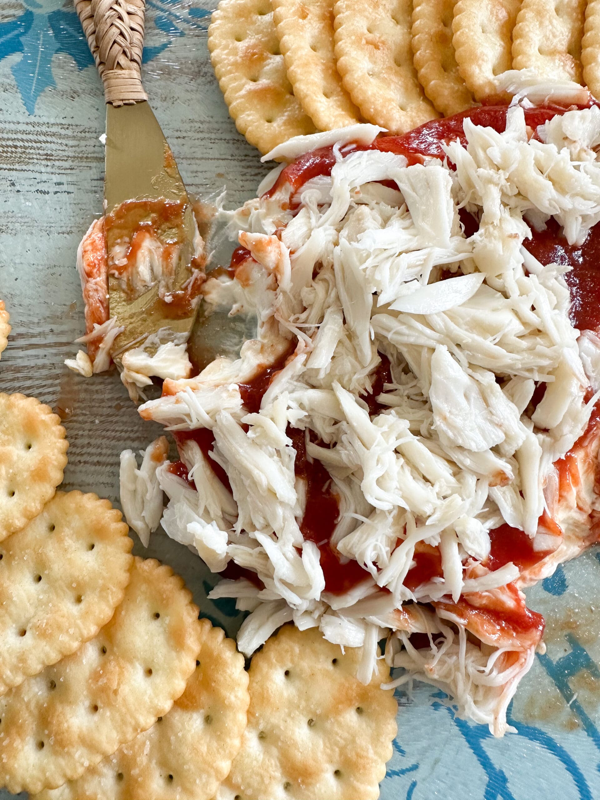 3 ingredient crab dip with serving knife covered in dip
