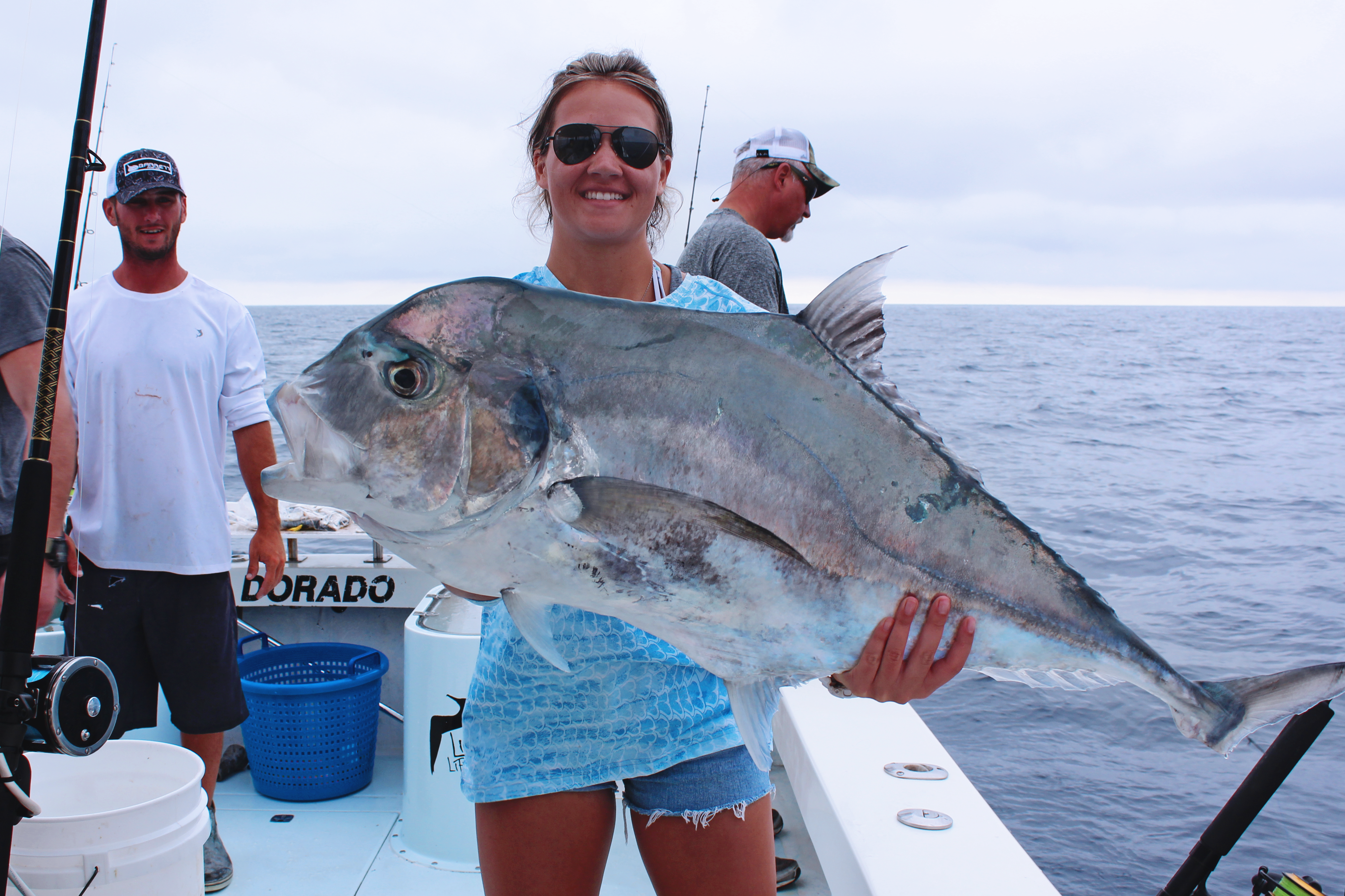 Smiling woman holding an African Pompano 
