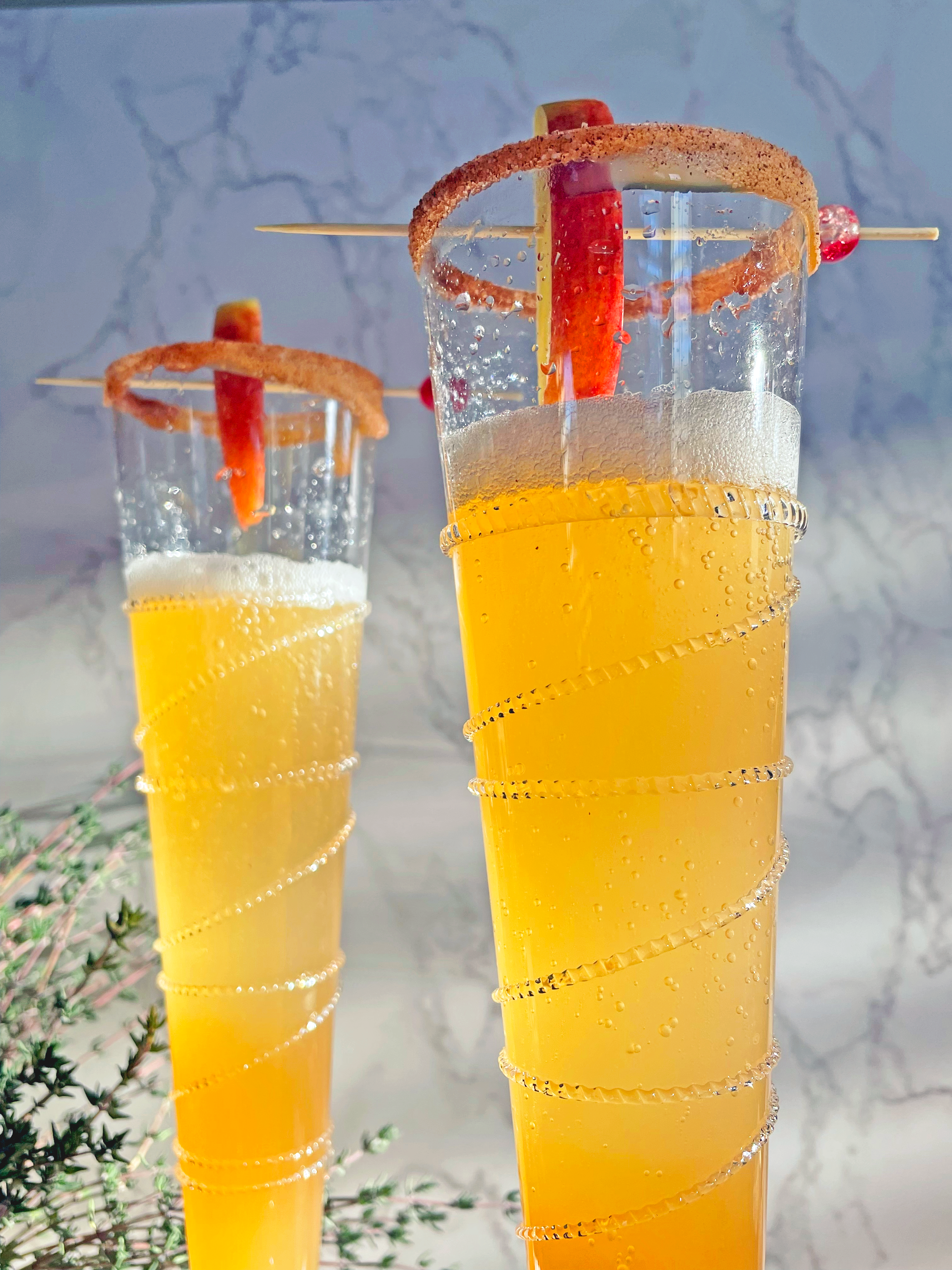 apple cider mimosas top of glasses
