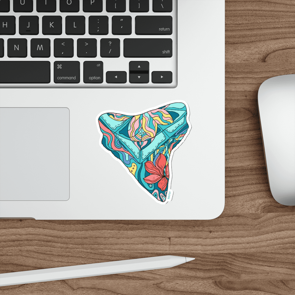 Colorful shark tooth sticker on laptop