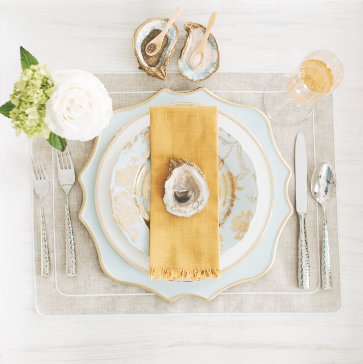 Gorgeous coastal place setting in blues, whites, golds, and natural tones